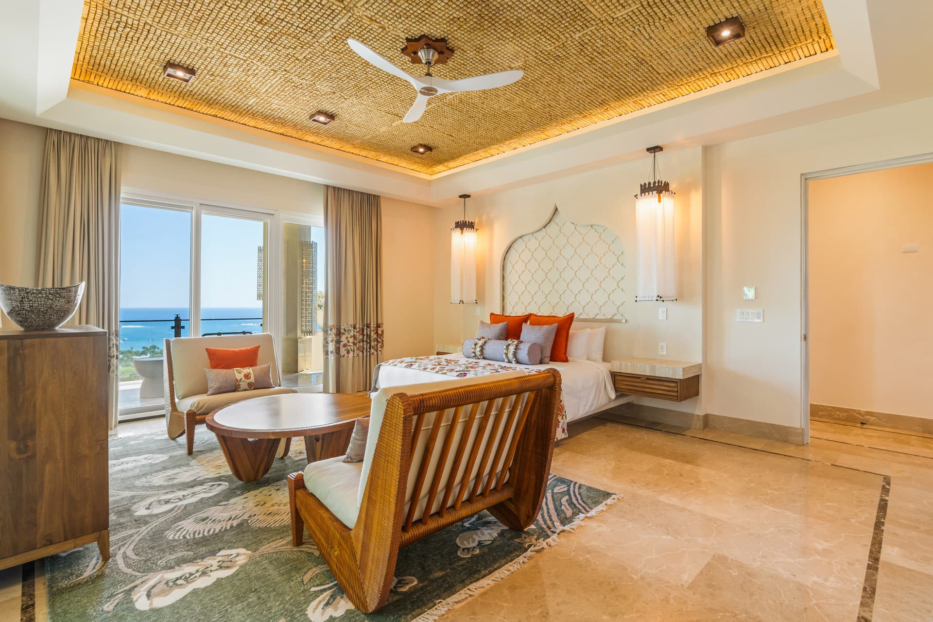 Main-floor primary suite at Villa Luciérnaga -- floating light columns, private terrace, Pacific views