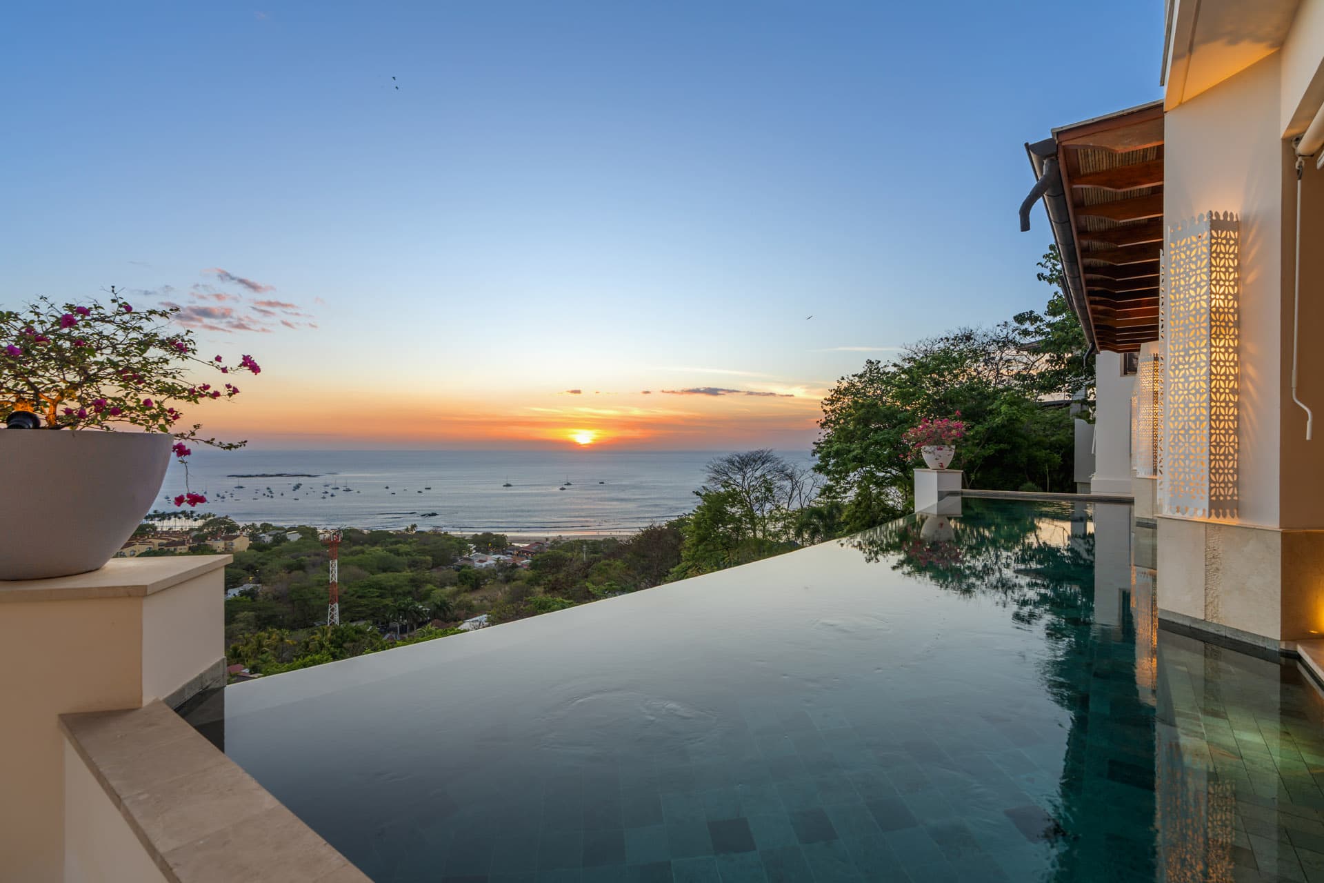 Infinity pool at sunset, its edge dissolving into Tamarindo Bay