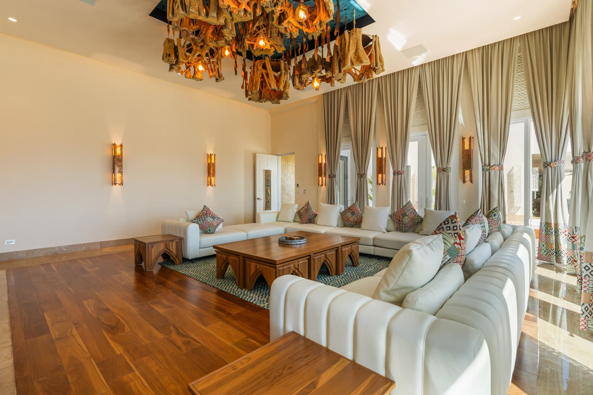 Theater Room with cinema screen, white sectional, and Matapalo chandelier